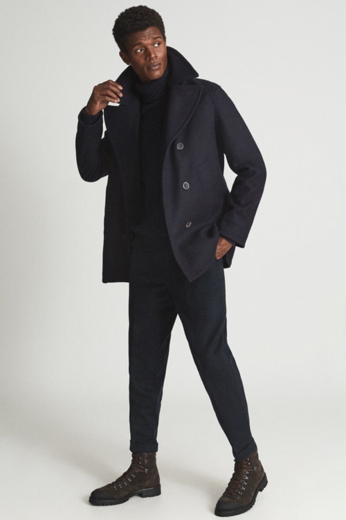 Men's black chinos, black roll neck, peacoat and black boots outfit