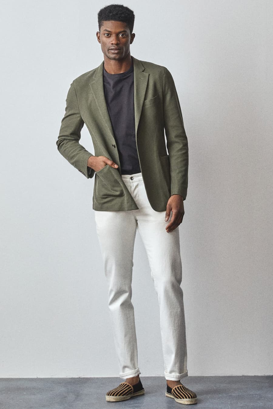 Men's white jeans, T-shirt, knitted green blazer and espadrilles outfit