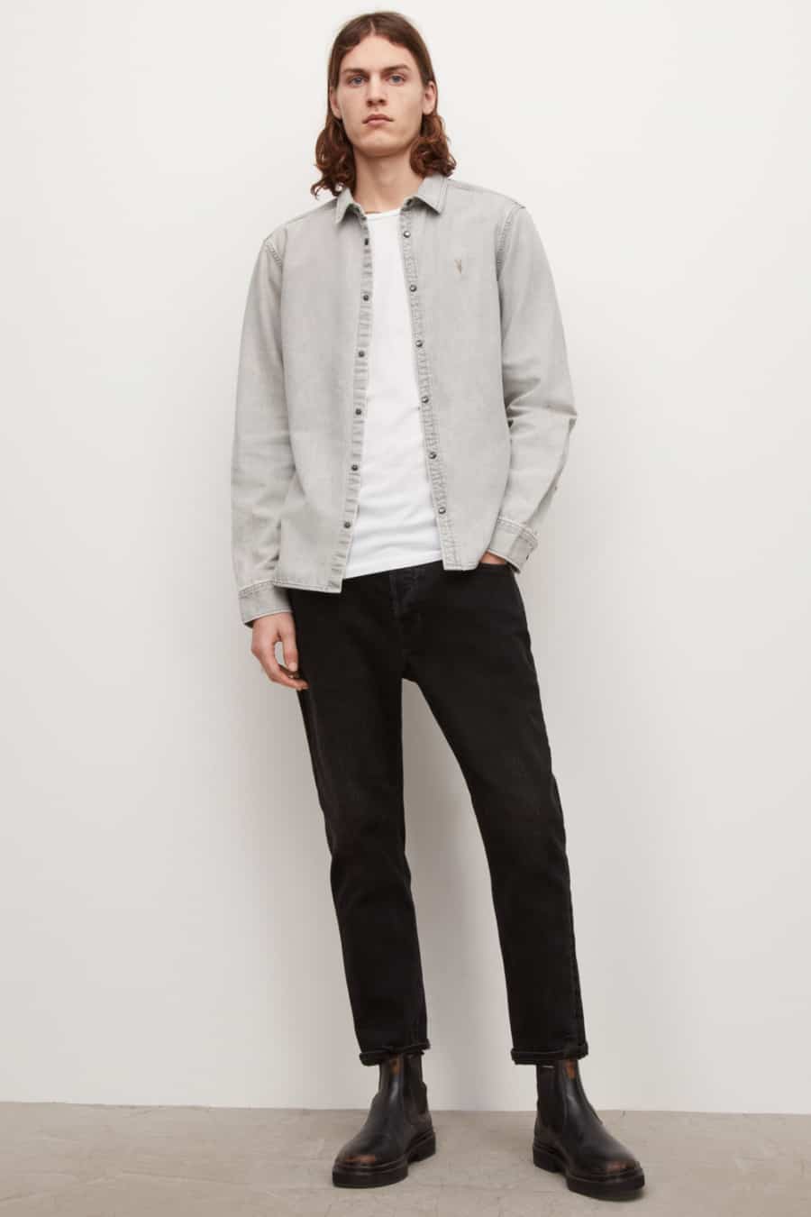 Men's black jeans, white T-shirt, grey denim shirt and brown Chelsea boots double denim outfit
