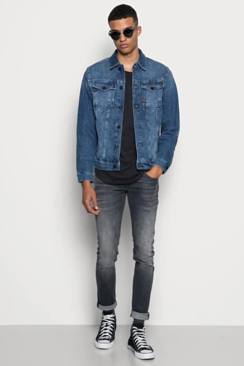 Men's double denim club outfit with black faded jeans, black T-shirt, mid blue denim jacket and black high-top sneakers
