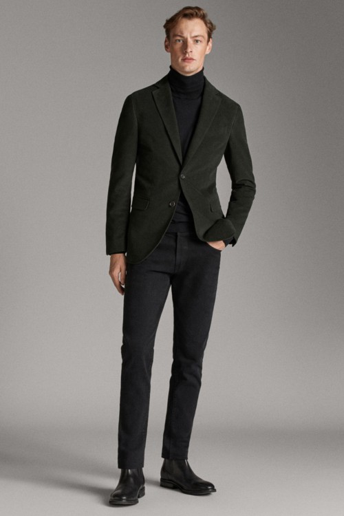 Men's black jeans, navy turtleneck, green blazer and black Chelsea boots outfit