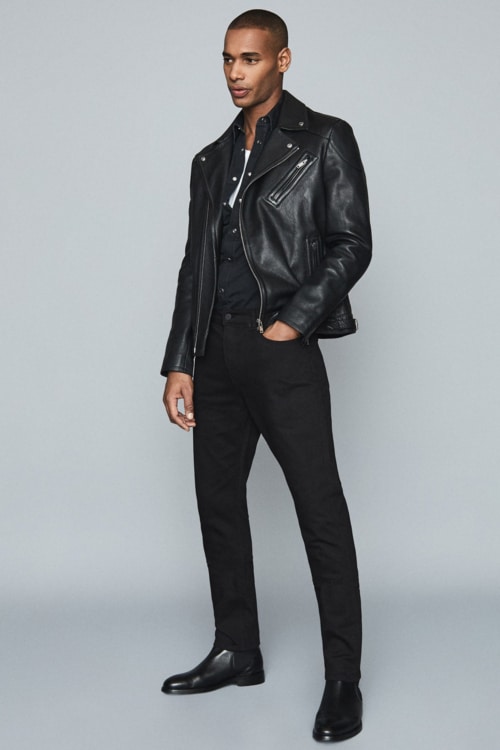 Men's black pants, black shirt and black leather biker jacket outfit worn with black Chelsea boots