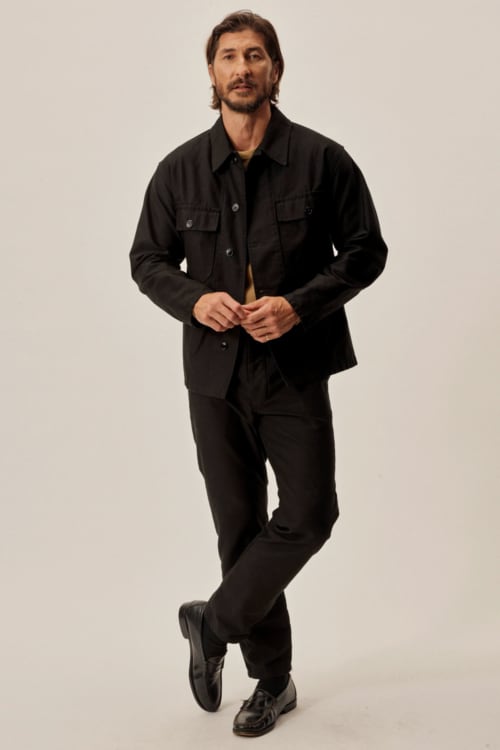 Men's all-black jeans, chore shacket and loafers outfit