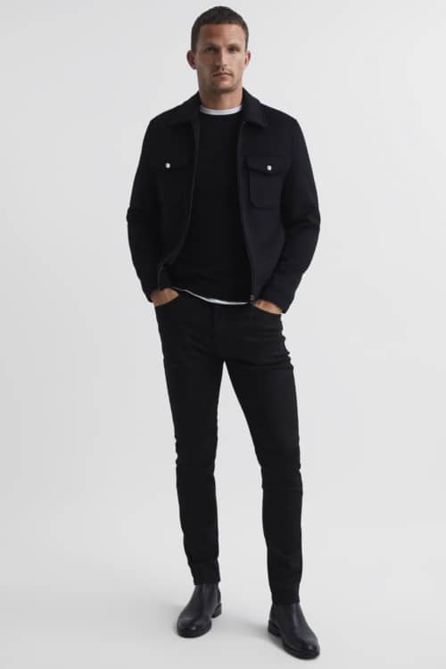 Men's all-black smart casual outfit with black jeans, Chelsea boots, crew neck sweater and overshirt