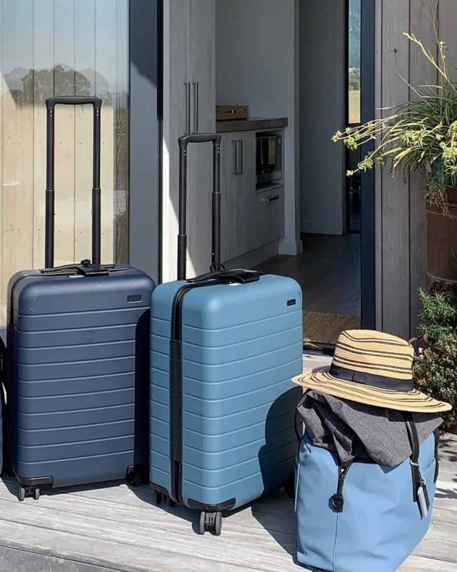 Two Away carry-on wheeled suitcases in blue