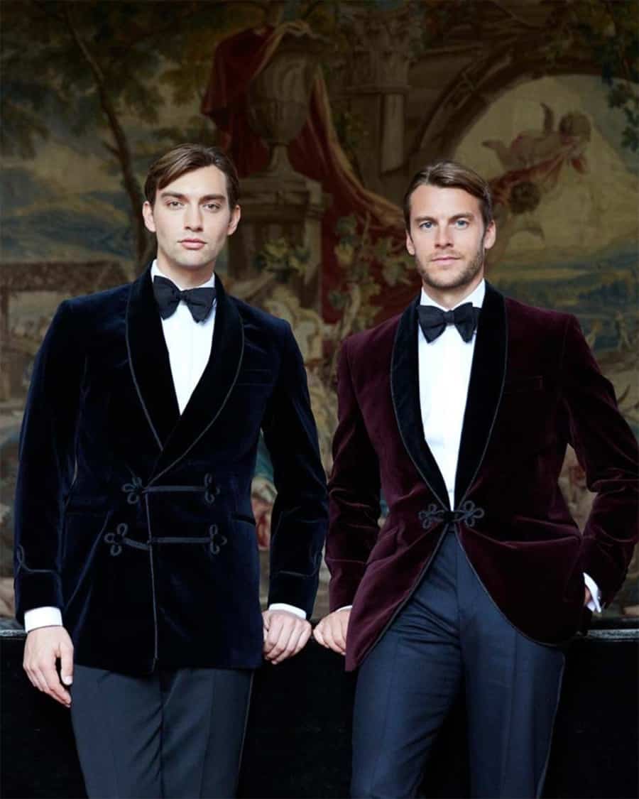 Two men wearing velvet smoking jackets, dress trousers, white dress shirts and black bow ties for black tie event