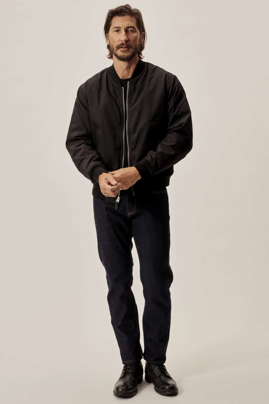 Men's dark raw jeans, black bomber jacket and black boots nightclub outfit