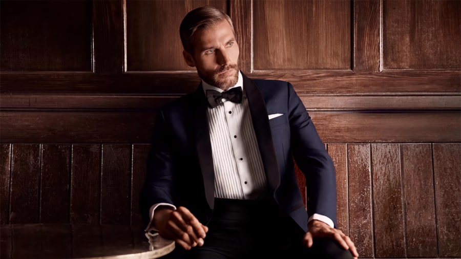 Man sitting wearing traditional black tie attire