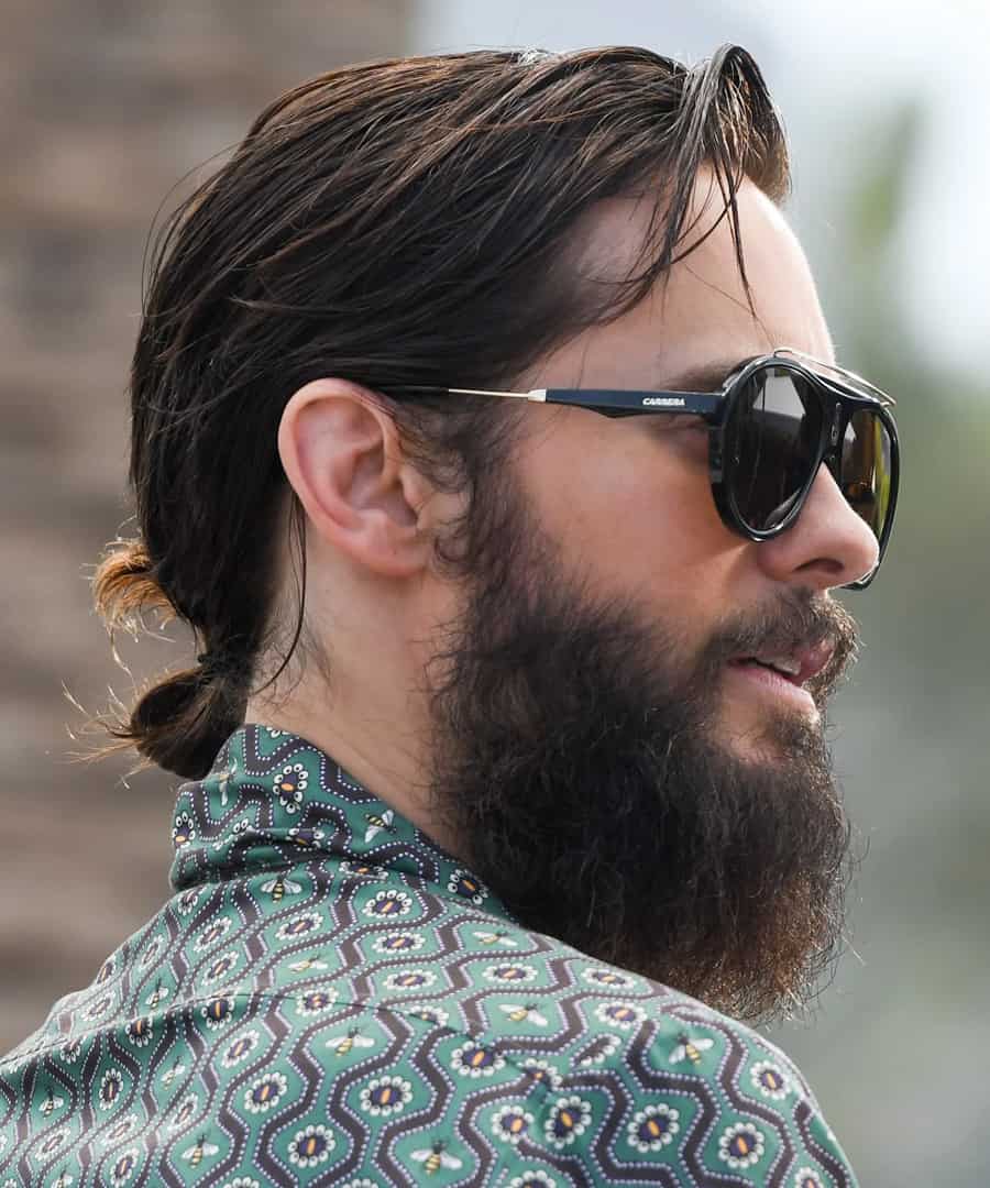 Modern men's long hair tied back into pony tail