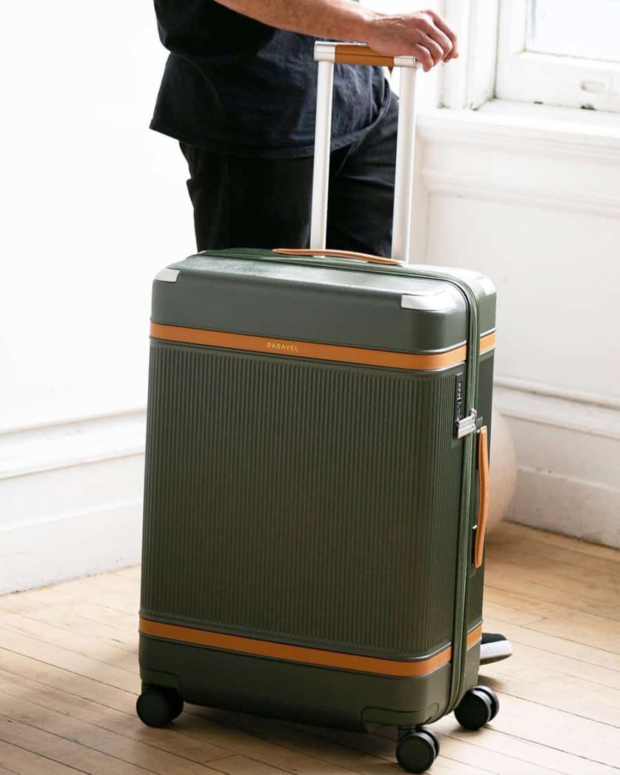 Man with luxury Paravel green wheeled case
