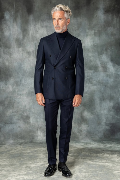 Men's navy double-breasted suit worn with navy roll neck sweater