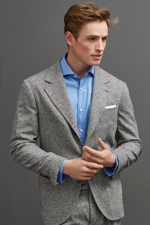 Men's grey flannel suit worn with sky blue shirt