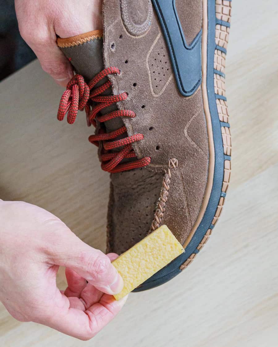 Removing stubborn stains from suede boots using a suede eraser block