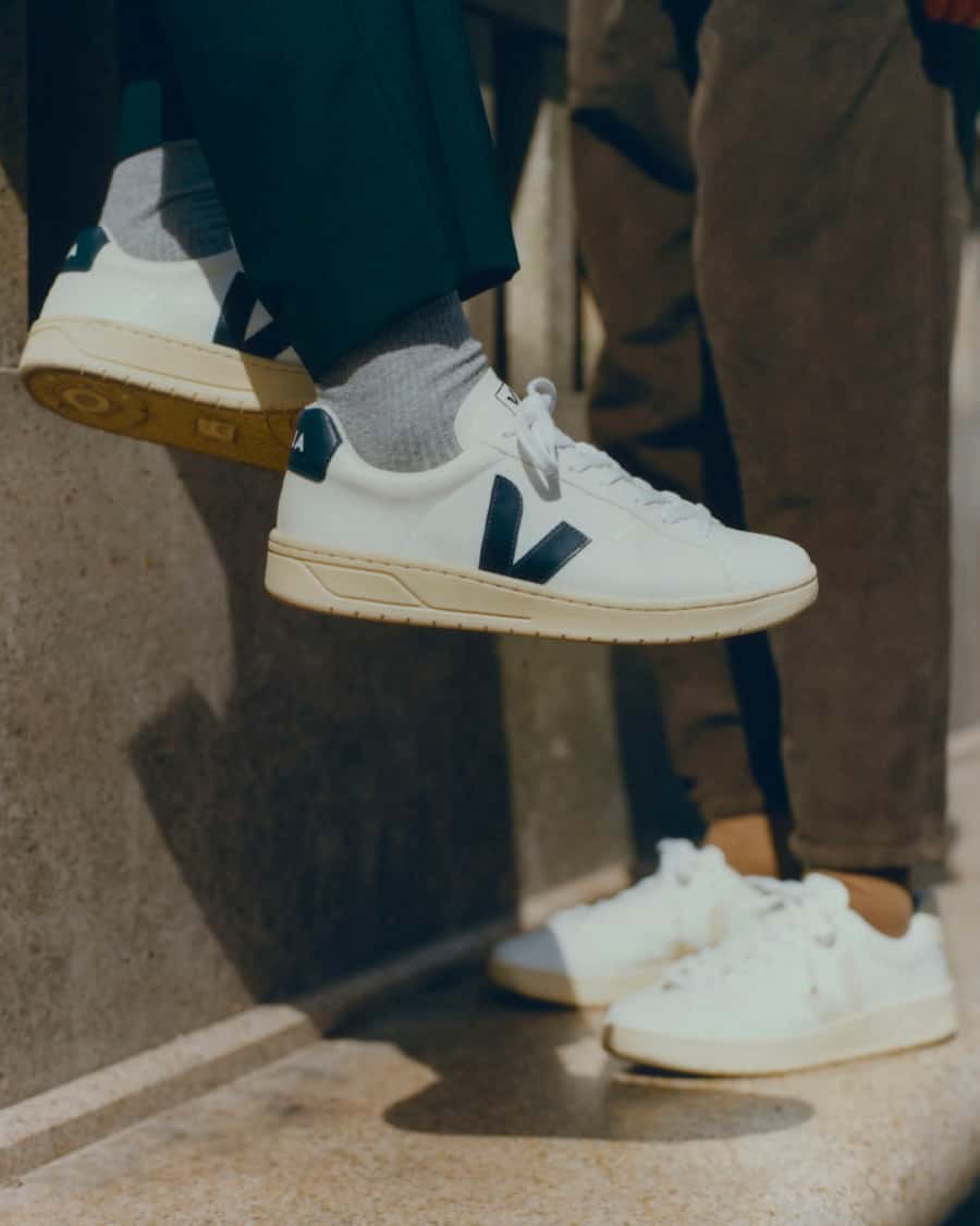 Veja leather sneakers on feet worn with cuffed trousers