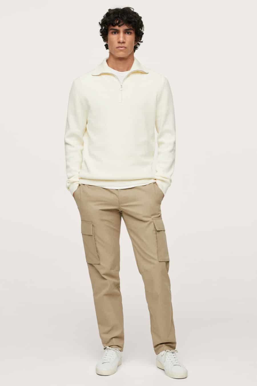Men's khaki cargo pants, white T-shirt, white zip-neck sweater and white sneakers outfit