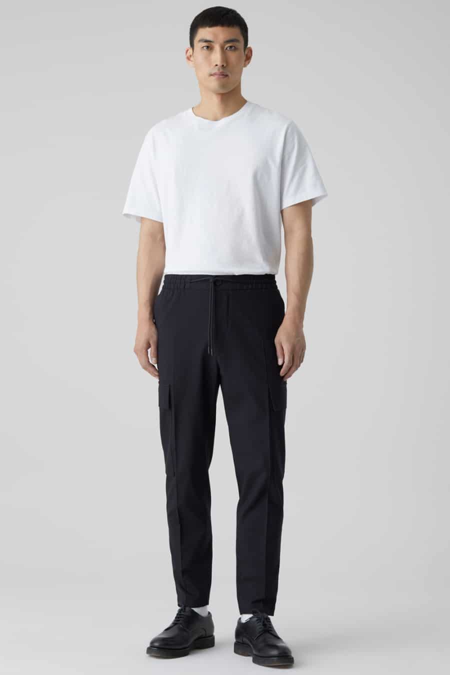 Men's black cargo pants, white tucked in T-shirt and black Derby shoes outfit