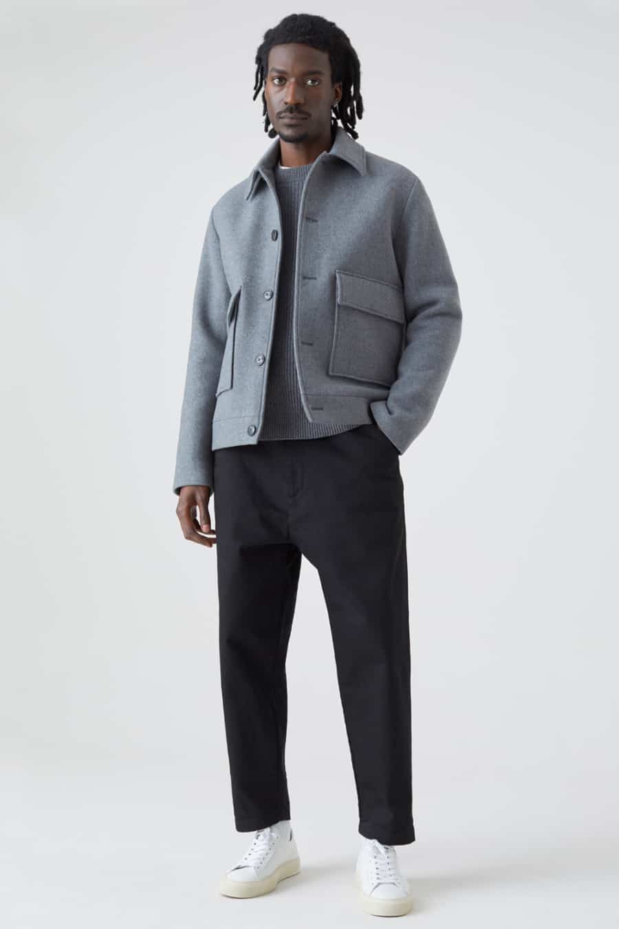 Men's black wide leg chinos, grey ribbed sweater, grey wool blouson jacket and white sneakers outfit