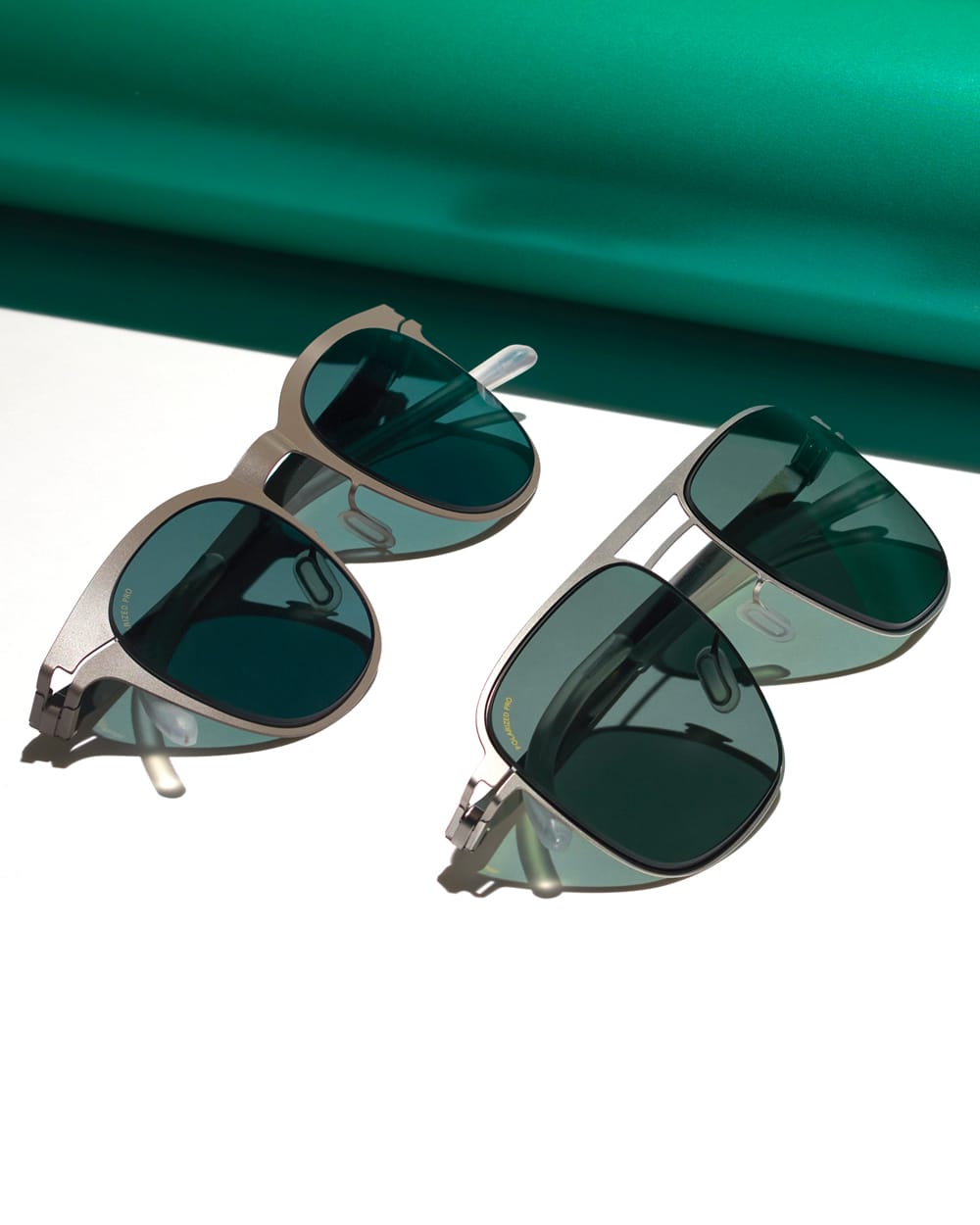 Two pairs of metal frame MYKITA sunglasses with green tinted lenses