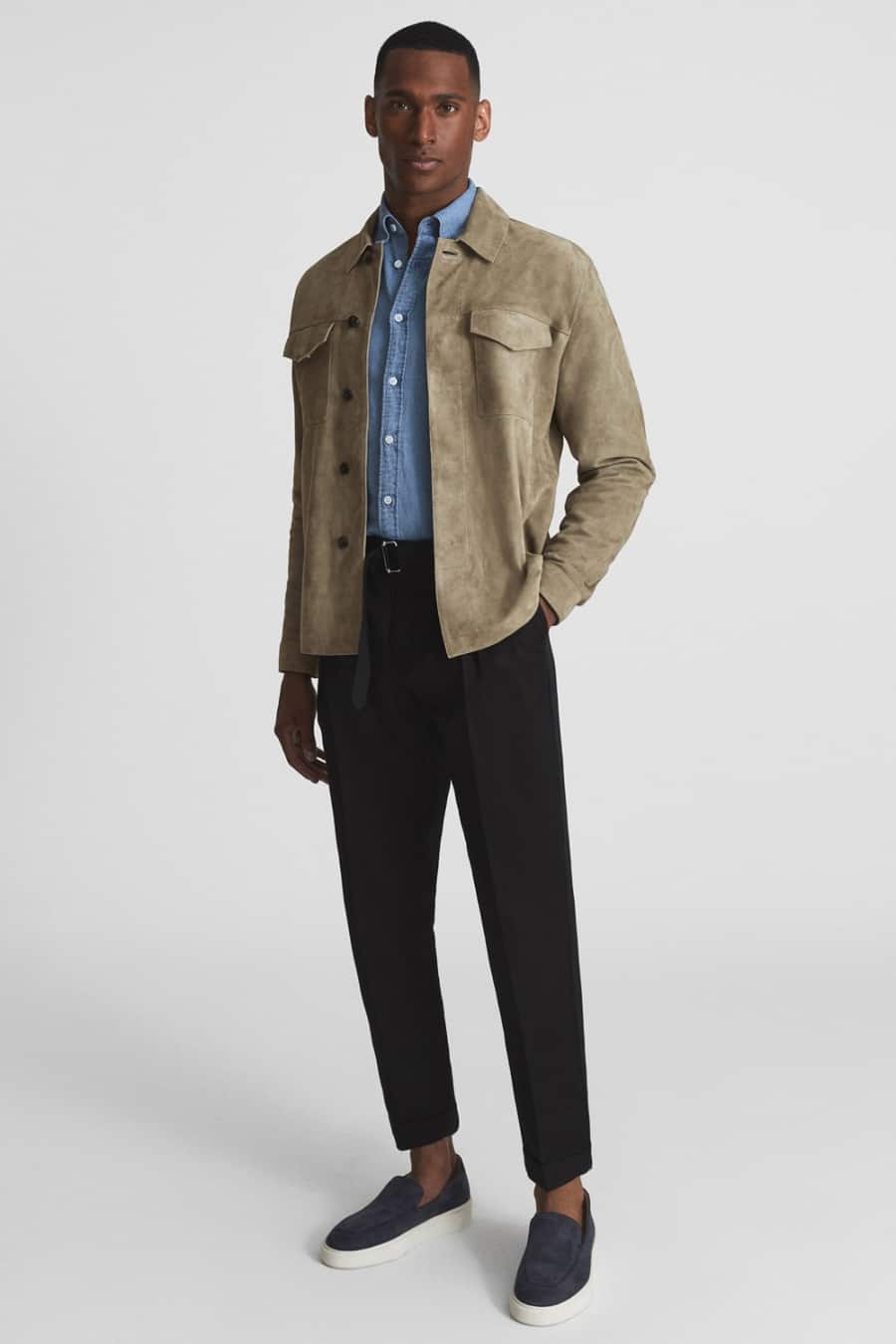 Men's black trousers, blue denim shirt, taupe suede overshirt and navy suede loafers outfit