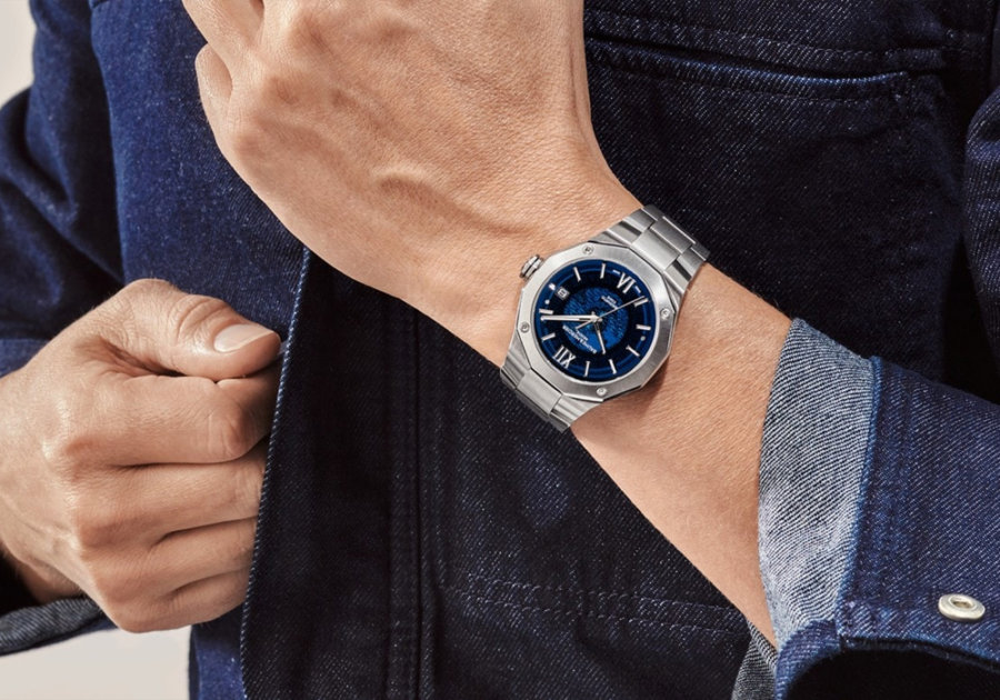 Man in a denim shirt wearing a blue dial Baume and Mercier luxury watch