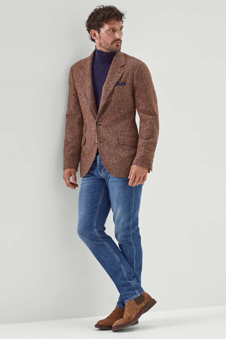 Men's stonewash jeans, navy turtleneck, brown wool blazer and brown suede Chelsea boots outfit
