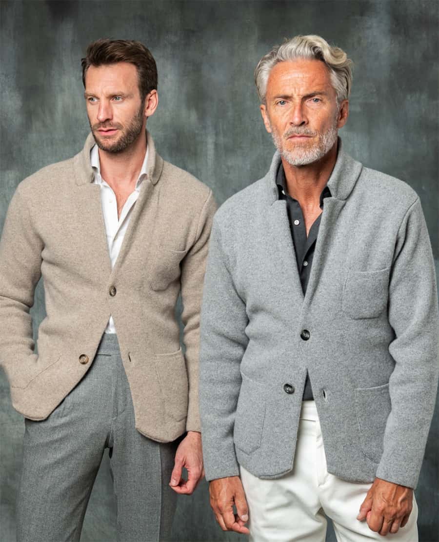 Two men wearing business casual clothing including dress pants and soft knitted blazers