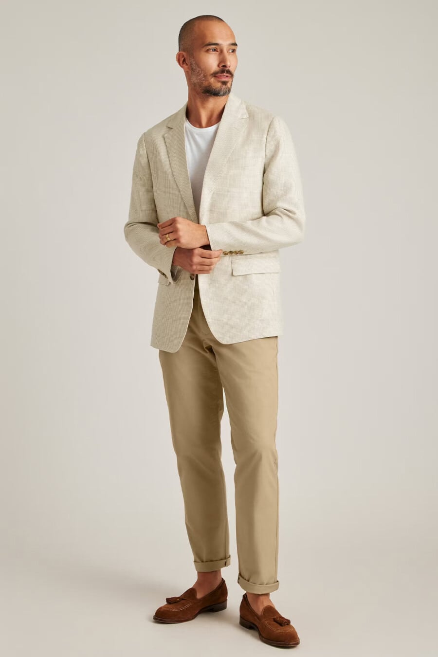 Men's khaki pants, white T-shirt, cream blazer and tan suede tassel loafers business casual outfit