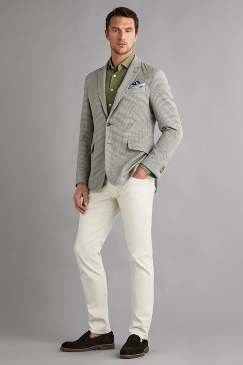 Men's white trousers, green shirt, grey blazer and suede loafers outfit