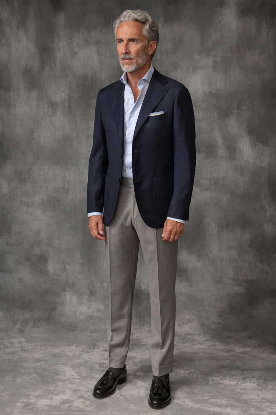 Men's grey dress pants, white shirt, navy blazer and black leather loafers outfit