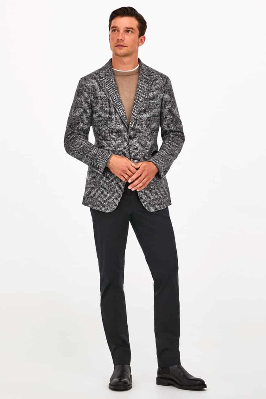 Men's black chinos, camel sweater, grey Prince of Wales check blazer, black Chelsea boots outfit