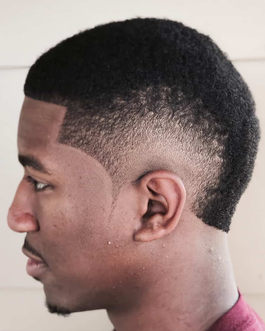 Black man with a buzz cut and burst fade