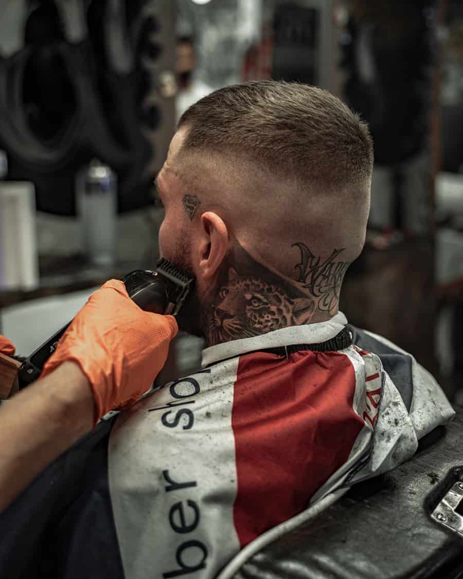A man getting a buzz cut fade in a barbershop