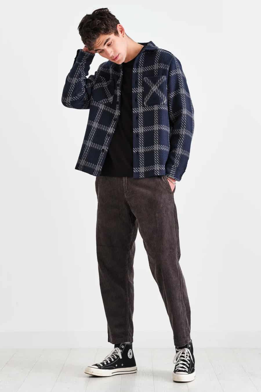 Men's corduroy trousers, black T-shirt, flannel check overshirt and black Converse high-tops outfit