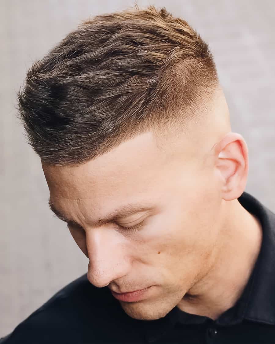 Man with a high and tight military haircut with a high skin fade