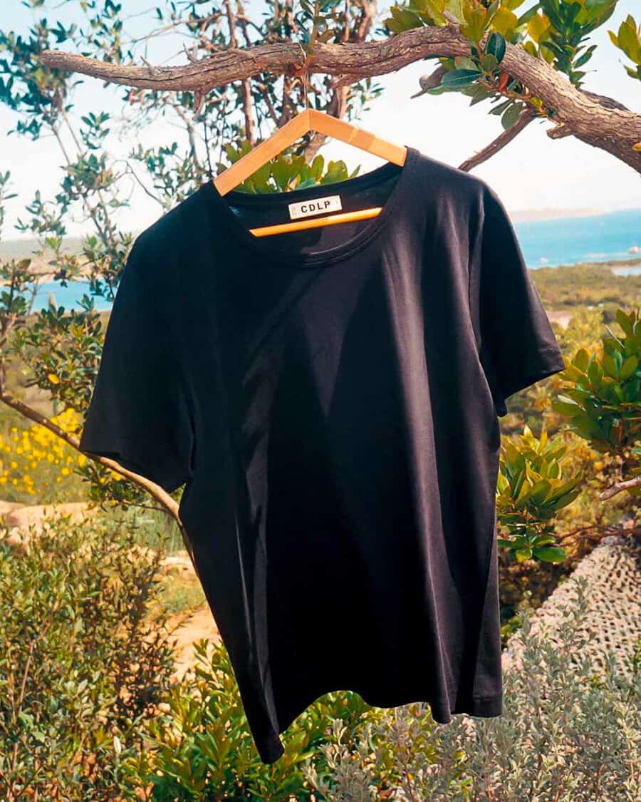 A luxury black men's T-shirt on a hanger outside