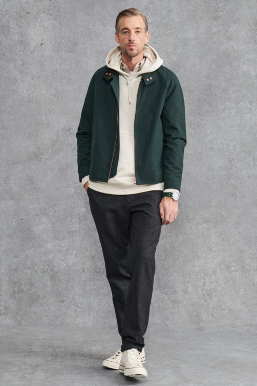 Men's charcoal wool trousers, cream hoodie, green Harrington jacket and white Converse All Star sneakers outfit
