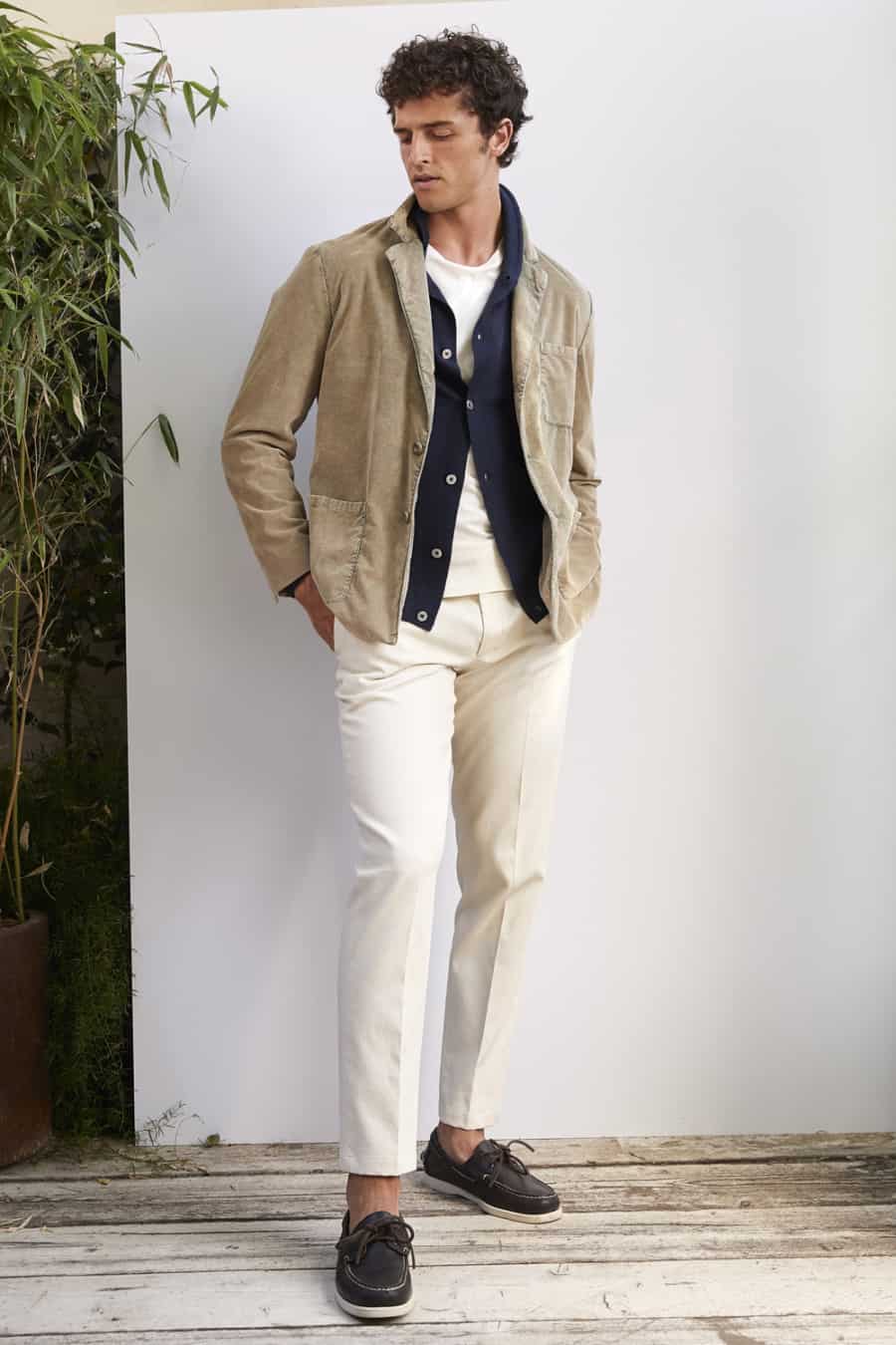 Men's off-white trousers, white tee, navy cardigan, twill unstructured blazer and deck shoes outfit