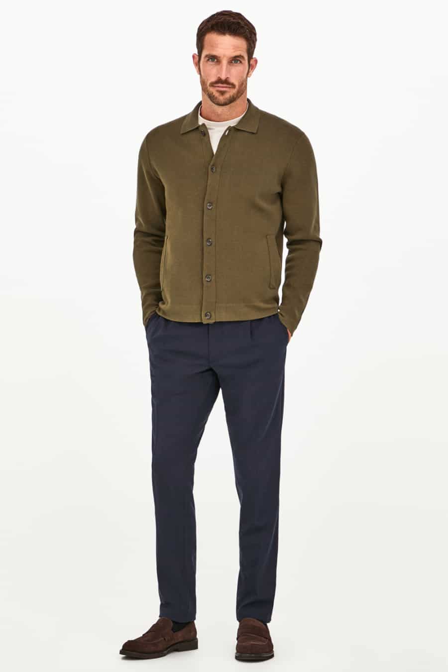 Men's navy chinos, white T-shirt, green collared cardigan and brown suede loafers outfit