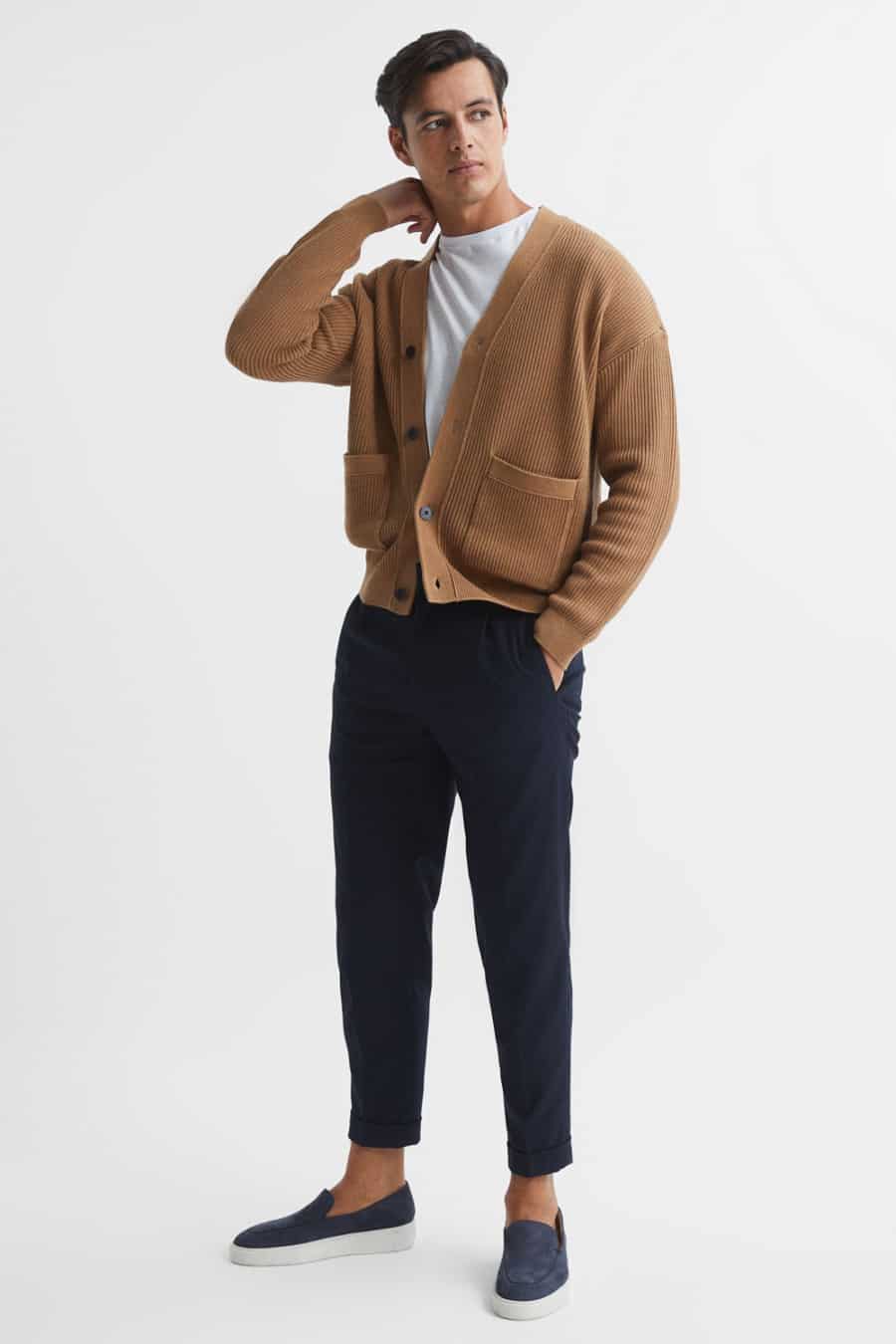 Men's navy chinos, white T-shirt, slouchy tan cardigan and suede loafers outfit