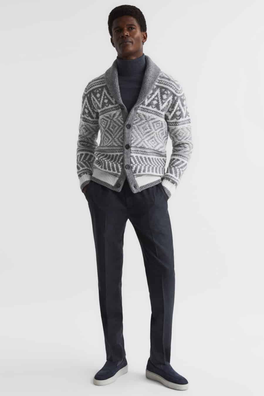 Men's charcoal trousers, charcoal turtleneck, grey fair isle cardigan and suede loafers outfit