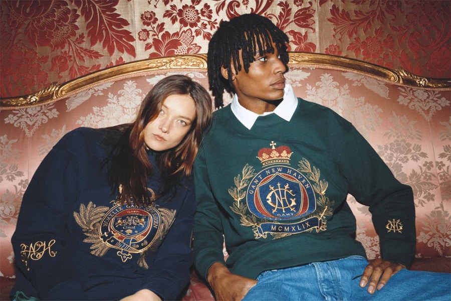 Man and woman wearing a preppy sweatshirt with white shirt and jeans