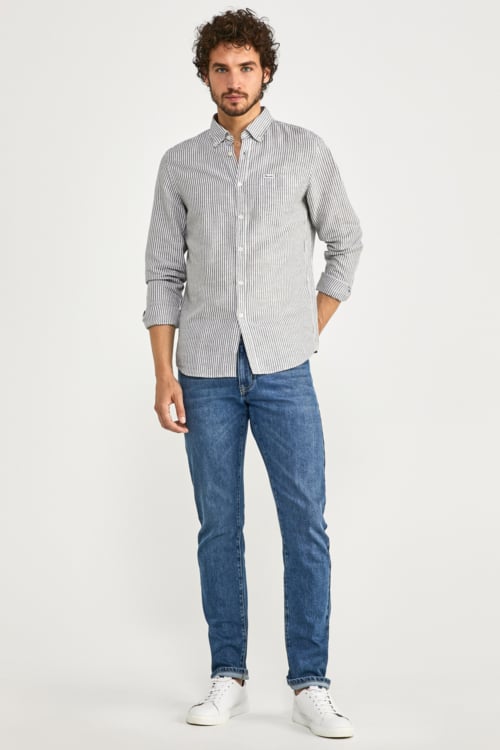 Men's mid wash jeans, striped Oxford shirt and white sneakers outfit