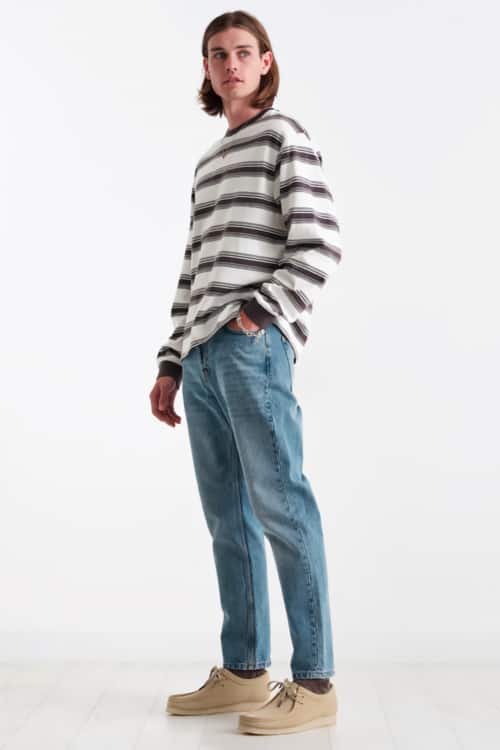 Men's light wash jeans, striped top and suede wallabee shoes outfit