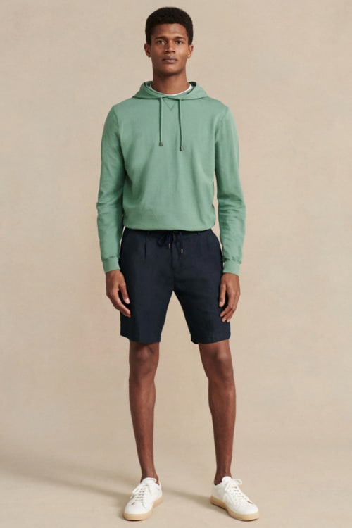 Men's bright green hoodie, navy shorts and white sneakers outfit
