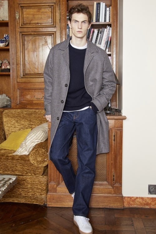 Men's raw denim jeans, navy sweater, checked overcoat and white sneakers outfit