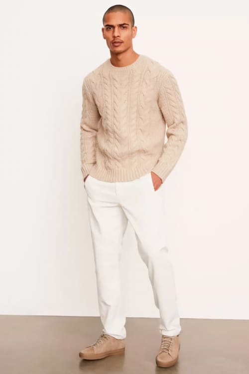 Men's white jpants, cream cable knit sweater and suede sneakers outfit
