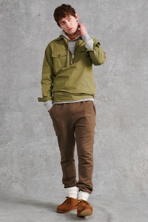 Men's brown sweatpants, grey hoodie, green pullover jacket and suede wallabee shoes outfit