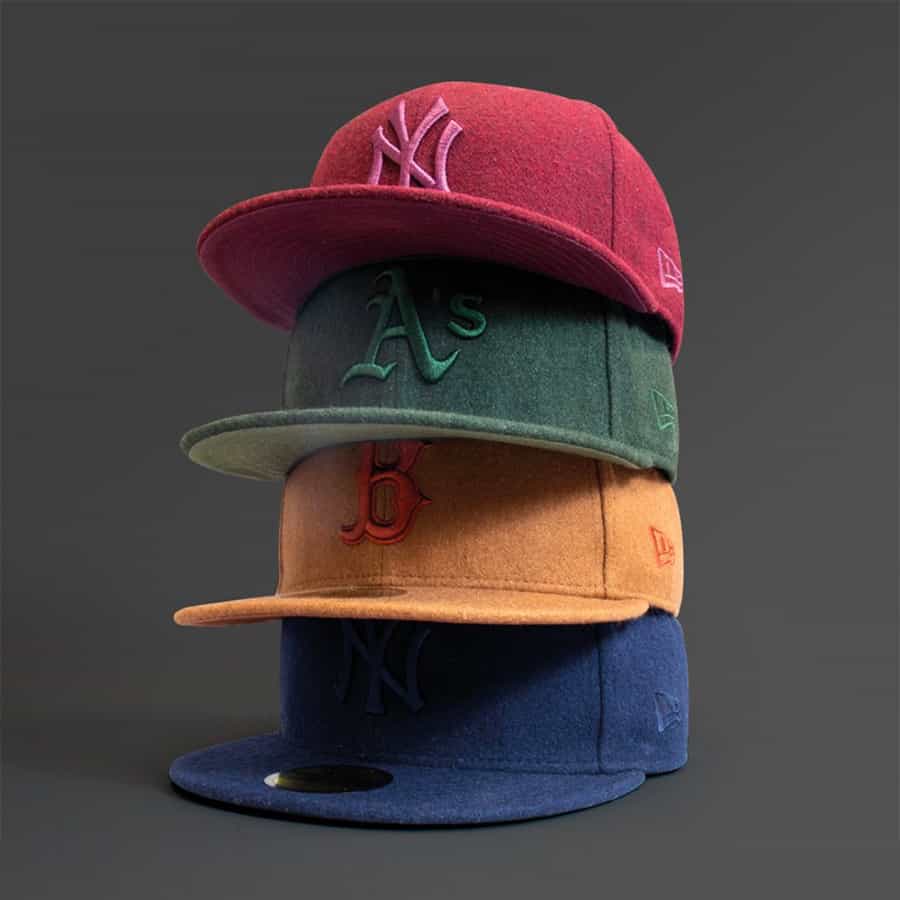 Stack of men's baseball caps in different colours on top of each other