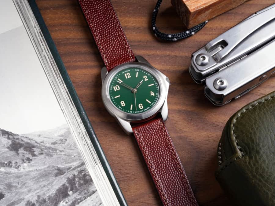anOrdain watch laid out on table with green dial