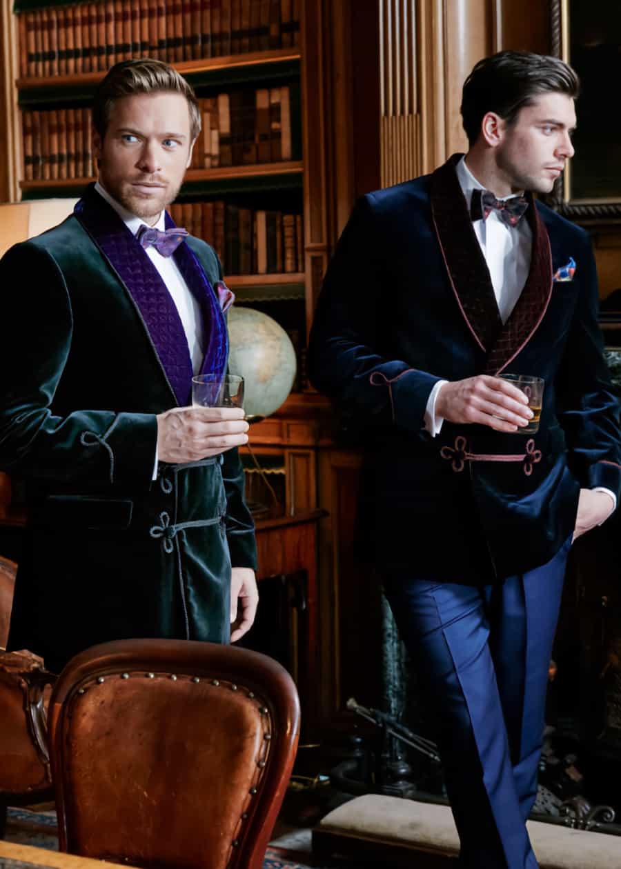 Two men wearing velvet smoking jackets in a gentleman's club
